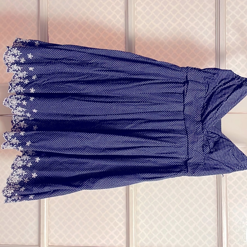 Navy blue  babydoll dress with white polka dot print and flower embroidered hem